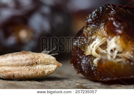 Fresh sweet dates on wooden background, close up
