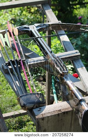 Crossbow, weapons producing boom.crossbow resting on tree trunk in autumn woods
