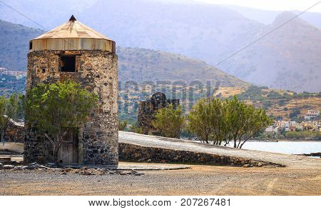Old windmills near famous summer resort Elounda, Eastern Crete, Greece