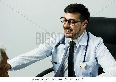 Male Doctor listening heart beat and breathing of Elderly Woman with Stethoscope with First Aid Medical Box.Community Health and Development Hospital In Remote Areas Development Fund Concept.