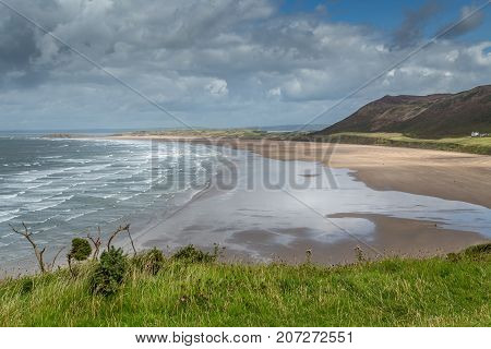 A landscape view of Rhossili Bay on the Gower Peninsula Swansea South Wales UK