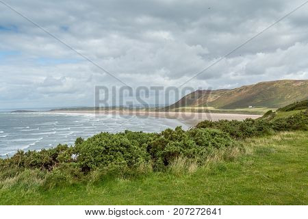 A landscape view of Rhossili Bay on the Gower Peninsula Swansea South Wales UK