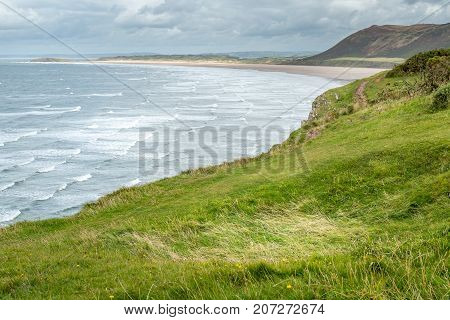 A landscape view of Rhossili Bay on the Gower Peninsula Swansea South Wales UK
