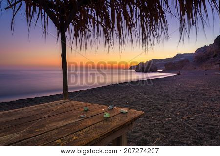 Summer view of a beach at sunset with stones on a table, Tertsa, Crete, Greece