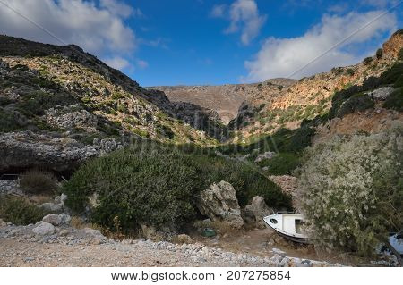 View in the mountains west of Crete with an old boat sleeping on the ground