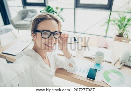 Successful Charming Relaxed Brown Haired Economist With Hairdo Is Making Photo On Camera, Taken At H