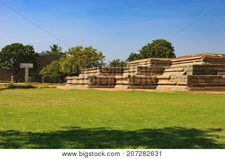 Hampi, India - November 20, 2012: Basement of Queen's Palace a part of the ruins of Zanana Enclosure in Hampi, Karnataka, India. Sign for tourists with the name of showplace