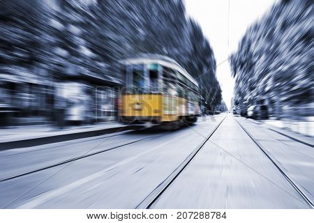 Blurred movement of a Old vintage orange tram in Milan Italy