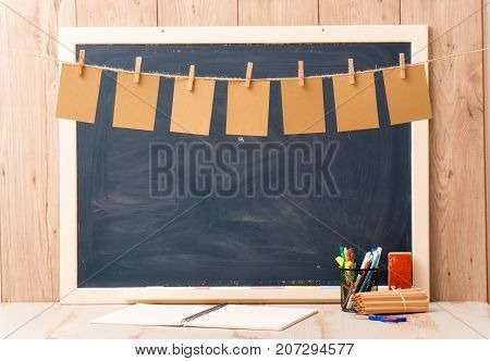 a blackboard with seven small sheets of paper