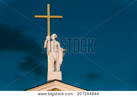 Vilnius, Lithuania. Close View Of Statue Of St. Helena With Cross On Roof Of Cathedral Basilica Of St Stanislaus And St Ladislaus.