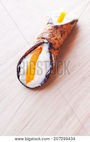 Sicilian Cannoli close up on wooden background traditional italian dessert with ricotta cheese. Fresh Canolli macro