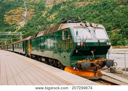 Flam, Norway. Famous Railroad Flamsbahn. Green Norwegian Train Near Railway Station. Electric train