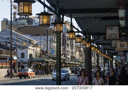 Kyoto, Japan - May 18, 2017: Pedestrians and traffic on the Shijio-Dori, major and busy shoppingstreet