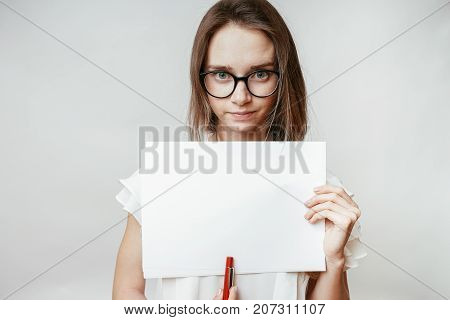 Teenager with mock up lank a4 on the white background
