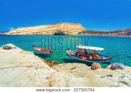 Matala beach with caves on the rocks that were used as a roman cemetery and at the decade of 70's were living hippies from all over the world, Crete, Greece