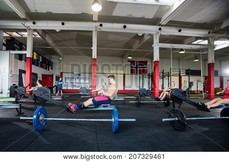 Clients Using Machines In Fitness Center