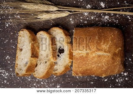 high-angle shot of some slices of pa de vidre or pa de coca, a bread typical of Catalonia, Spain, on a rustic wooden table