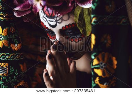 Portrait of a girl with sugar skull makeup over black background. Calavera Catrina. Dia de los muertos. Day of The Dead. Halloween.  