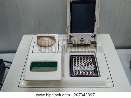 Opened polymerase chain reaction (PCR)  cycler machine with DNA samples