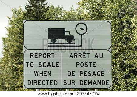 Sign for Trucking Weigh Station scale report weight on highway in Quebec Canada