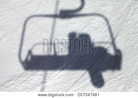 Shadows From Chair Lift With Snowboarder