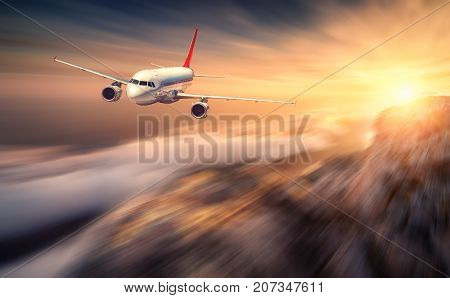Modern Airplane Mith Motion Blur Effect Is Flying Over Low Clouds