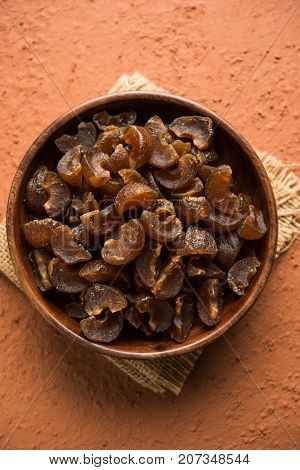 Ayurvedic Amla Candy, which is dried and salty-sweet or chatpata in taste and digestive. Served in a wooden bowl, selective focus