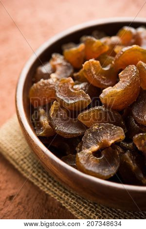 Ayurvedic Amla Candy, which is dried and salty-sweet or chatpata in taste and digestive. Served in a wooden bowl, selective focus