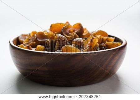 Ayurvedic Amla Candy, which is dried and salty-sweet or chatpata in taste and digestive. Served in a wooden bowl, selective focus