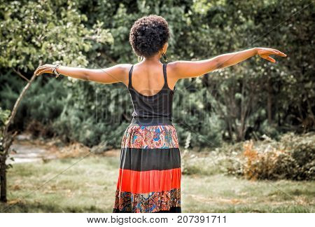african girl is dancing traditional dance in the nature
