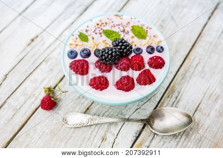 A bowl of healthy and delicious smoothie with grains and fresh berry fruit.