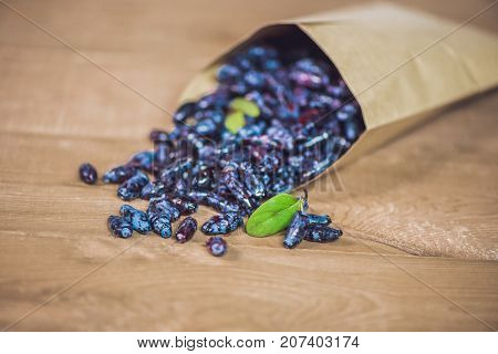 Fresh Honeysuckle Blue Berry Fruits With Leaf On A Wooden Background