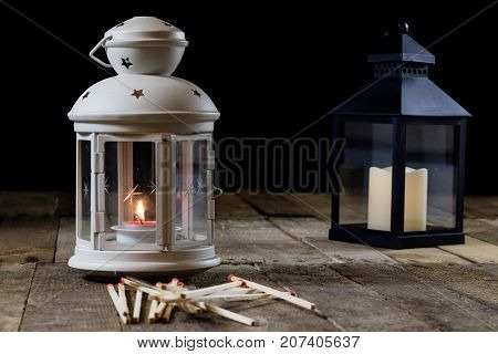 Two Small Lanterns On A Wooden Table. Candle In Old Latarence. Wooden Table.