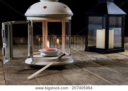Two Small Lanterns On A Wooden Table. Candle In Old Latarence. Wooden Table.