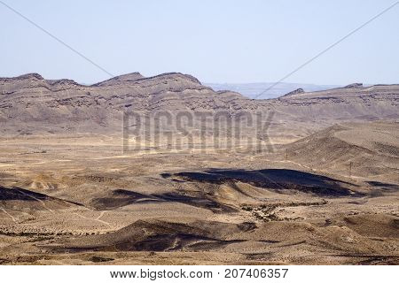 Large crater Ha-Makhtesh Ha-Gadol near Yeruham and the road leading to the colored sands (Israel)