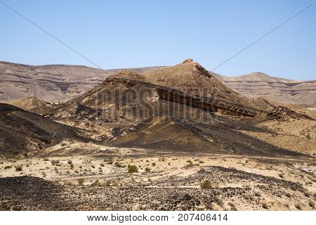 The mountain along the crater of Ha-Gadol and the black stones covering the surface (Israel)