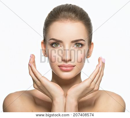 Beautiful face of young caucasian woman with perfect health skin  - isolated on white.  Skin care concept. Female Model touches face.