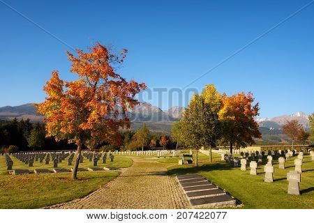 VAZEC, SLOVAKA - OCTOBER 1, 2017 : German military cemetery in autumn with High Tatras mountains in the background and many graves of german soldiers killed in the Second World War.
