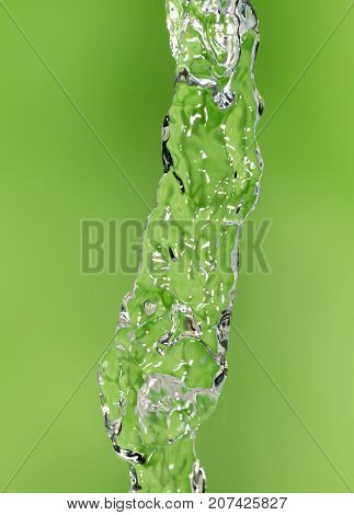 a jet of water on a green background