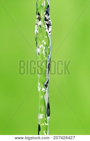 a jet of water on a green background