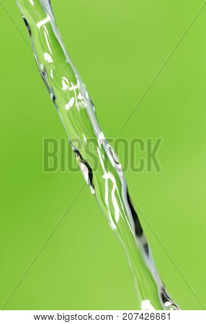 a jet of water on a green background
