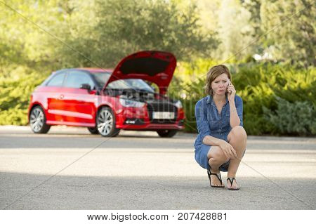 young attractive desperate and confused woman stranded on roadside with broken car engine failure crash accident calling on mobile phone for mechanic assistance in insurance company concept