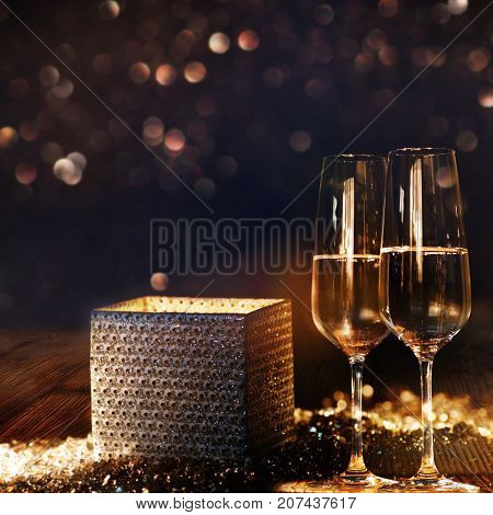 Bright radiant gift box with champagne and bokeh background for congratulation