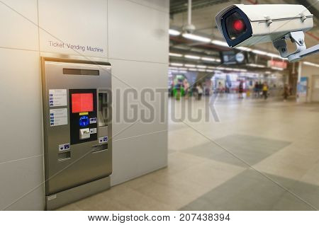 CCTV security indoor camera system operating with self service ticket or ticket vending machine at train station transportation surveillance security safety technology concept