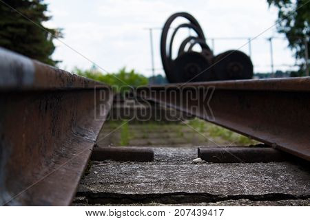 Old rusty metal rails and other metal rolling in the museum exposition.