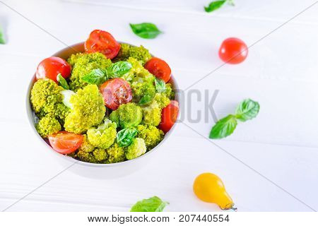 Salad Bowl With Cherry Tomatoes, Boiled Broccoli, Basil And Fresh Ingredients On The White Wooden Ba