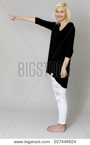 The portrait of young woman showing on side.