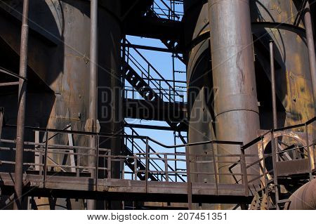 Old rusty designs of an old blast furnace at an abandoned factory.