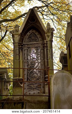 Old ornate iron door. Entrance to an old tomb crypt at a cemetery.