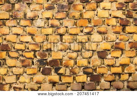 The old brickwork of the old building is made of yellow brick.